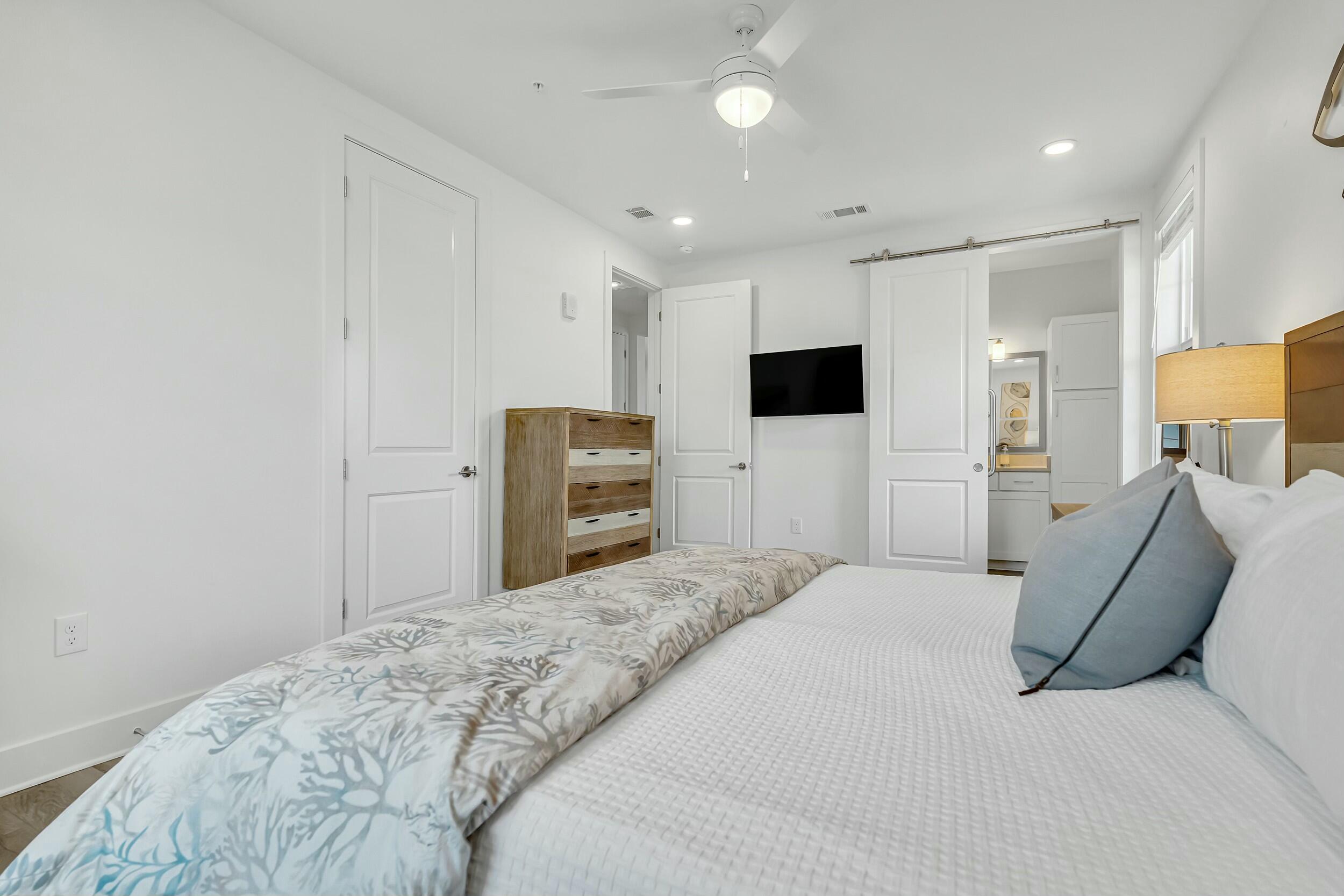 179 South County Highway 393, Unit 445 Santa Rosa Beach, FL 32459 - Photo 18 of 50 a bedroom with a large bed and flat screen tv
