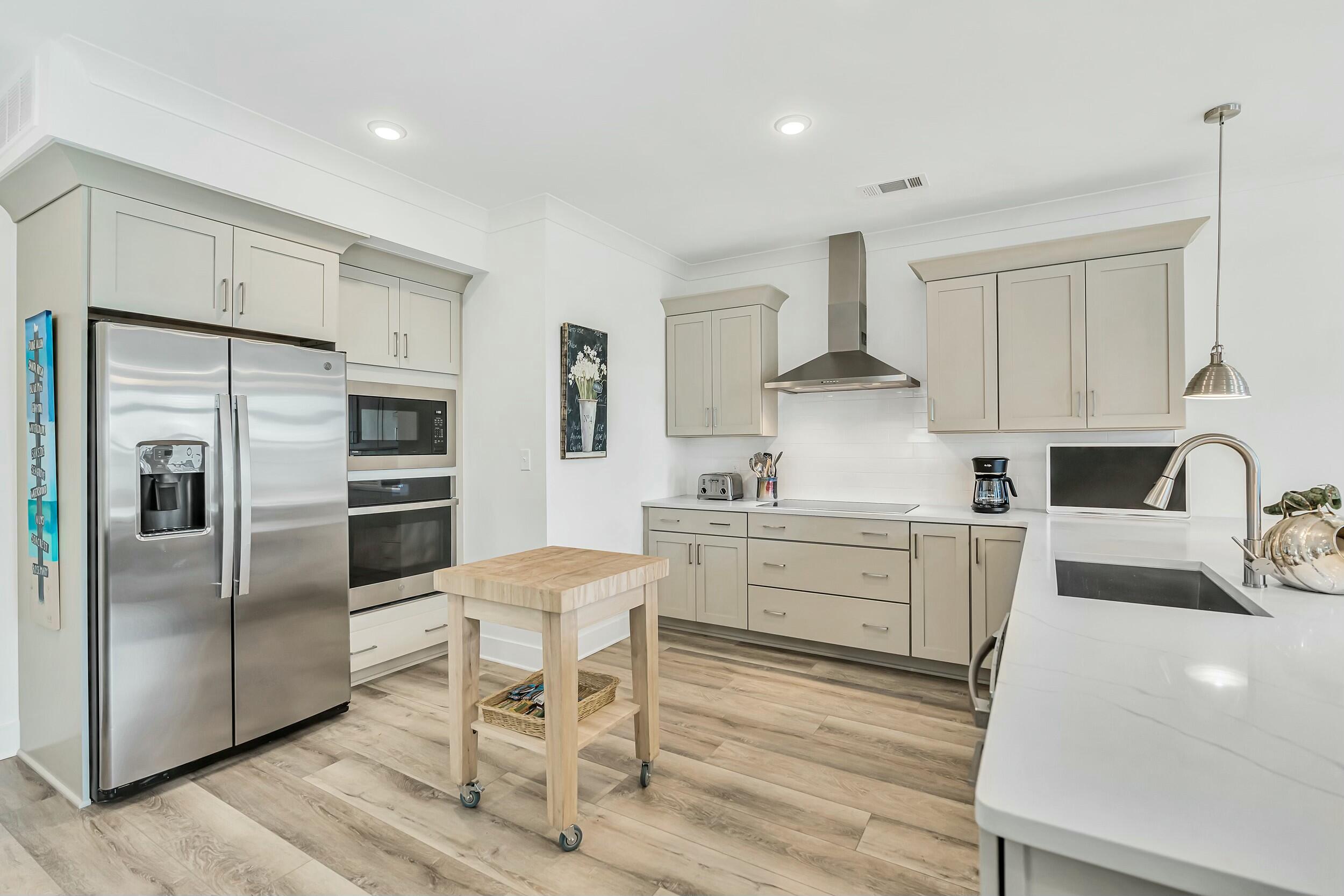 179 South County Highway 393, Unit 445 Santa Rosa Beach, FL 32459 - Photo 2 of 50 a kitchen with a refrigerator cabinets and wooden floor