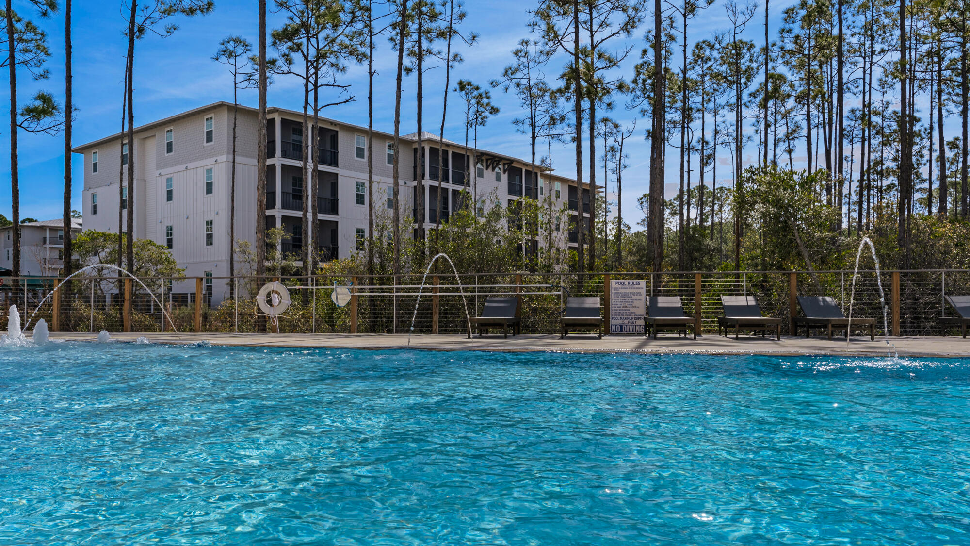 179 South County Highway 393, Unit 445 Santa Rosa Beach, FL 32459 - Photo 22 of 50 a view of a house with backyard and trees