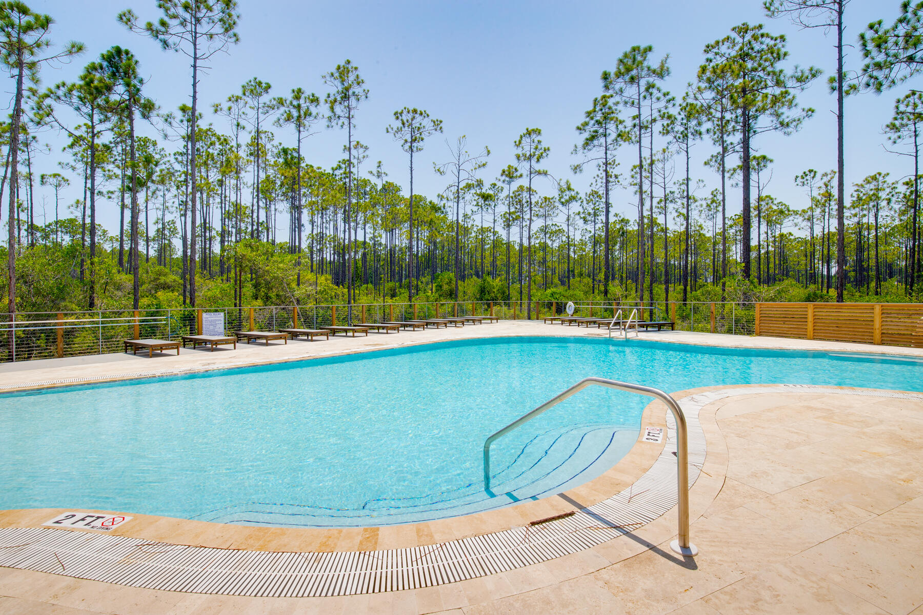 179 South County Highway 393, Unit 445 Santa Rosa Beach, FL 32459 - Photo 26 of 50 a view of a swimming pool with a yard and palm trees