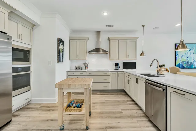 a kitchen with cabinets oven and a sink
