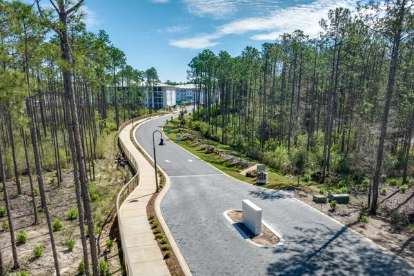 an aerial view of house with yard lake and mountain view in back