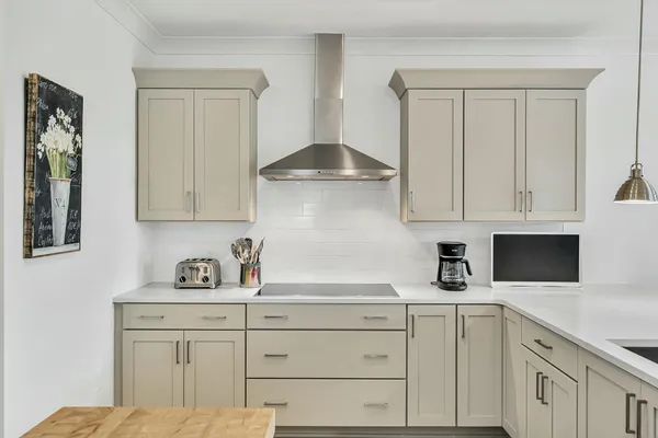 a kitchen with white cabinets and a sink