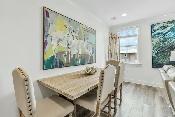 a dining room with furniture and wooden floor