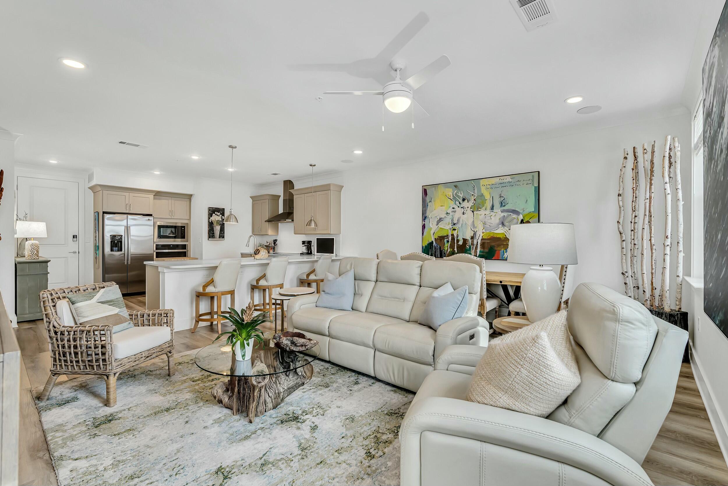 179 South County Highway 393, Unit 445 Santa Rosa Beach, FL 32459 - Photo 9 of 50 a living room with furniture and a dining table with kitchen view