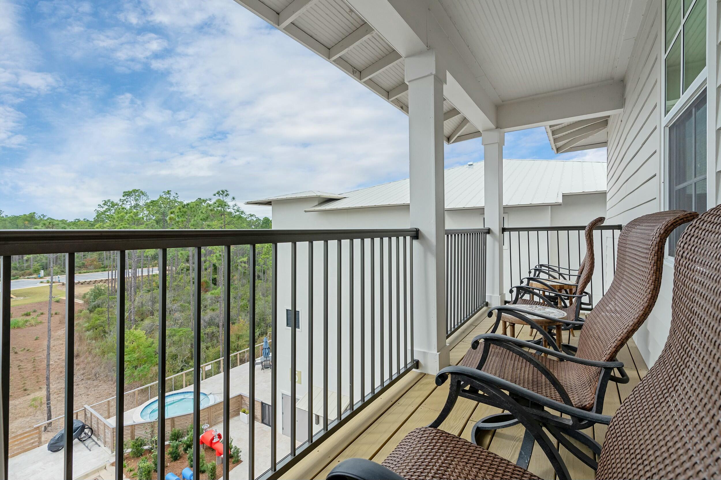 179 South County Highway 393, Unit 445 Santa Rosa Beach, FL 32459 - Photo 10 of 50 a balcony with chairs and a table