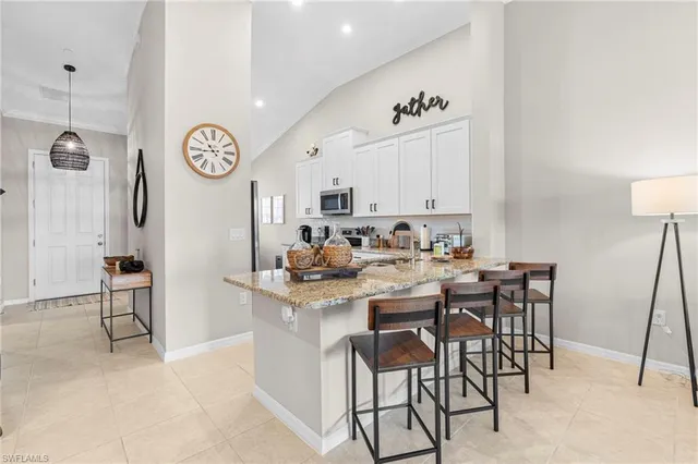 a bathroom with a granite countertop sink mirror vanity and toilet