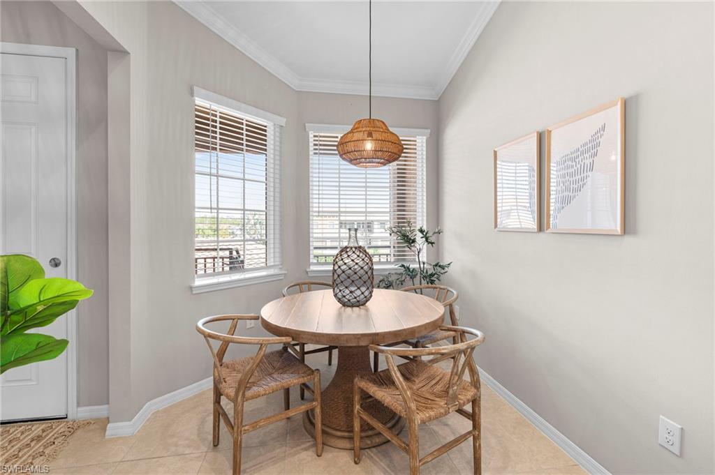 9402 Pocida Court, Unit 202 Naples, FL 34119 - Photo 18 of 31 Dining area featuring crown molding and light tile patterned floors