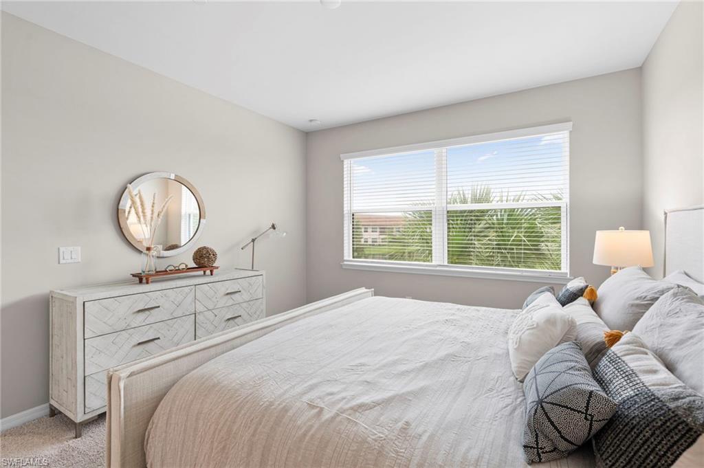 9402 Pocida Court, Unit 202 Naples, FL 34119 - Photo 20 of 31 Bedroom featuring carpet floors and baseboards
