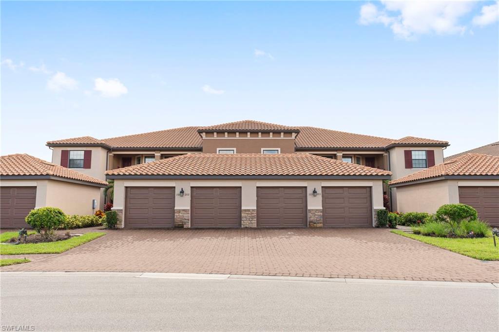 9402 Pocida Court, Unit 202 Naples, FL 34119 - Photo 2 of 31 Mediterranean / spanish house featuring stucco siding, stone siding, and a tile roof