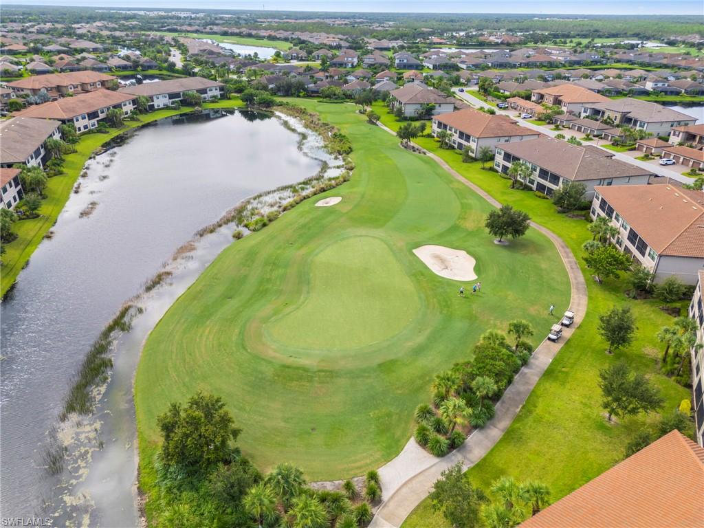 9402 Pocida Court, Unit 202 Naples, FL 34119 - Photo 5 of 31 Aerial view of residential area with a large body of water and a golf course