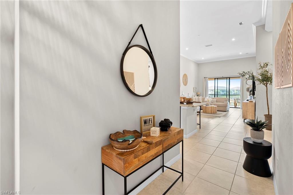 9402 Pocida Court, Unit 202 Naples, FL 34119 - Photo 10 of 31 Hall with light tile patterned flooring and recessed lighting