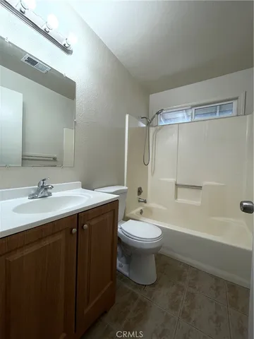 a bathroom with a double vanity sink toilet and shower