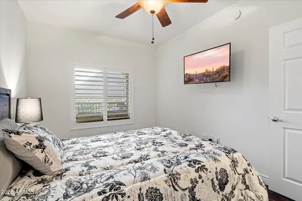 a bedroom with a bed and a lamp