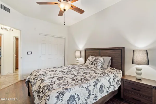 a bedroom with a bed and lamp