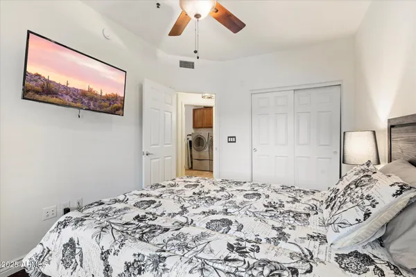 a bedroom with a bed and a painting on the wall
