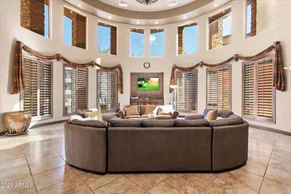 a room with pool table and windows