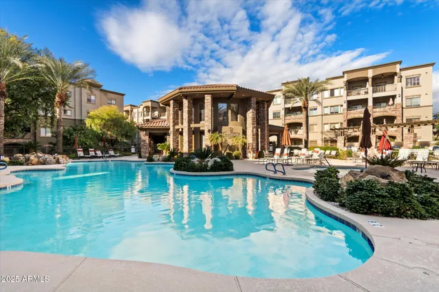 a view of a swimming pool with outdoor seating