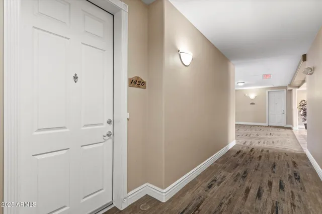 a view of a hallway with wooden floor