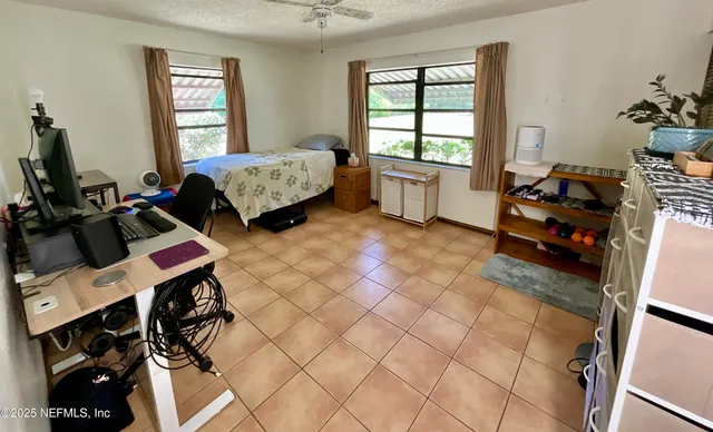 a bedroom with furniture and a window