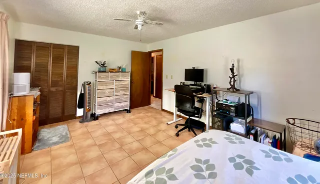 a view of a bedroom with workspace and bedroom