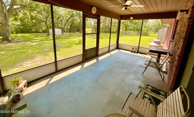 a view of an empty room with a floor to ceiling window