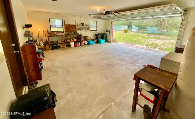 a view of an empty room with a fireplace and a large window