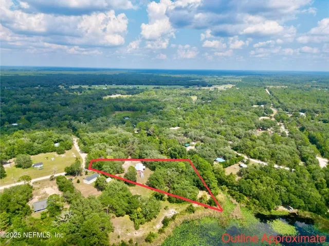 a view of house with garden in front of it