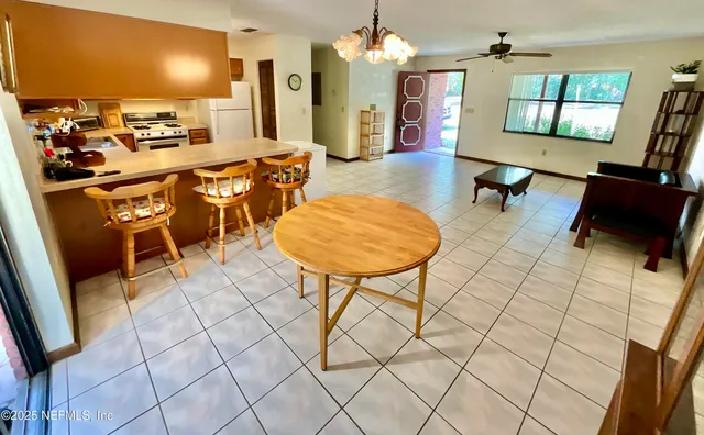 a very nice looking open dining room with a table and chairs