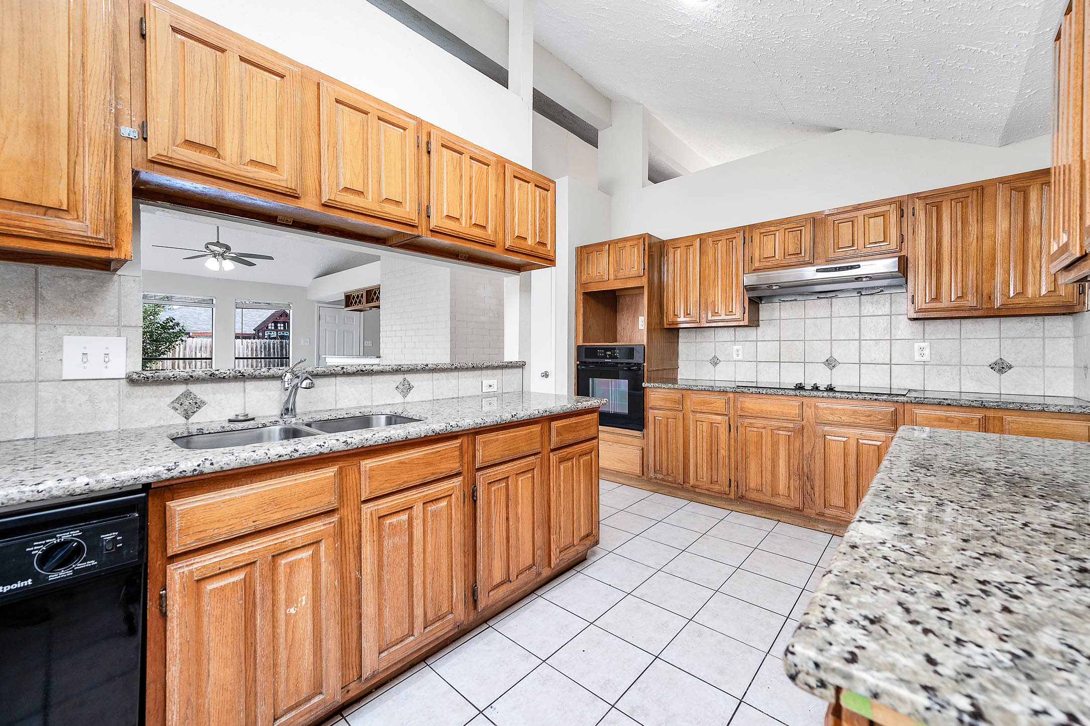 2015 Echo Ridge Sugar Land, TX 77478 - Photo 12 of 29 a kitchen with stainless steel appliances granite countertop a sink stove and cabinets