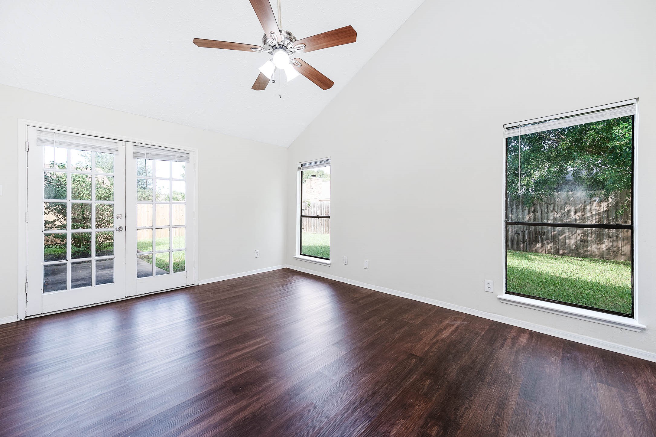 2015 Echo Ridge Sugar Land, TX 77478 - Photo 16 of 29 a view of an empty room with wooden floor and a window