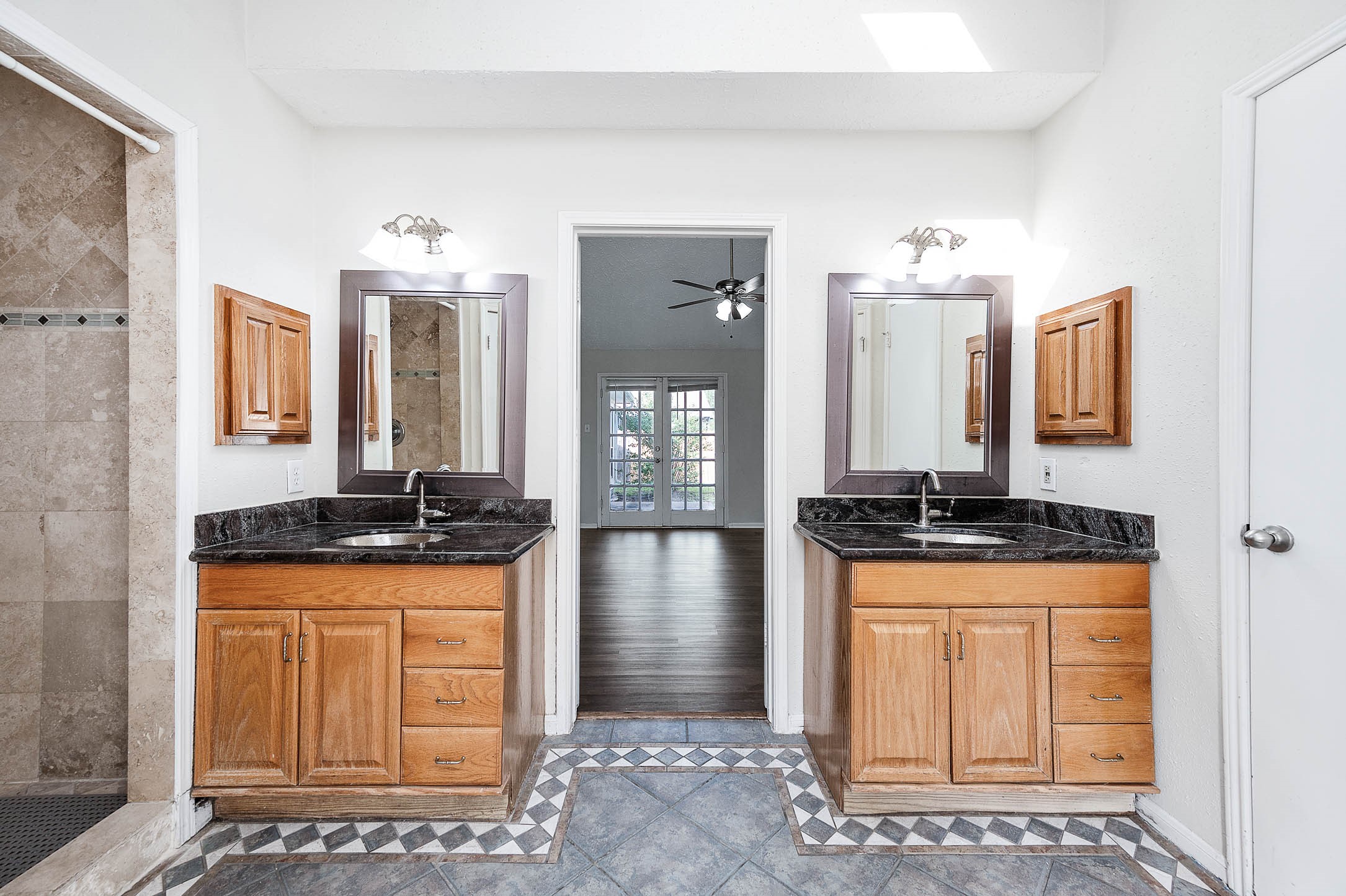 2015 Echo Ridge Sugar Land, TX 77478 - Photo 19 of 29 a kitchen with granite countertop a sink a stove and cabinets