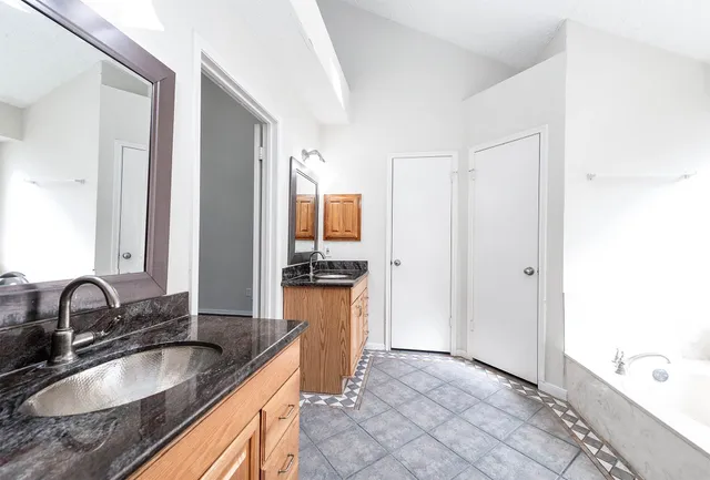 a kitchen with granite countertop a sink and a stove