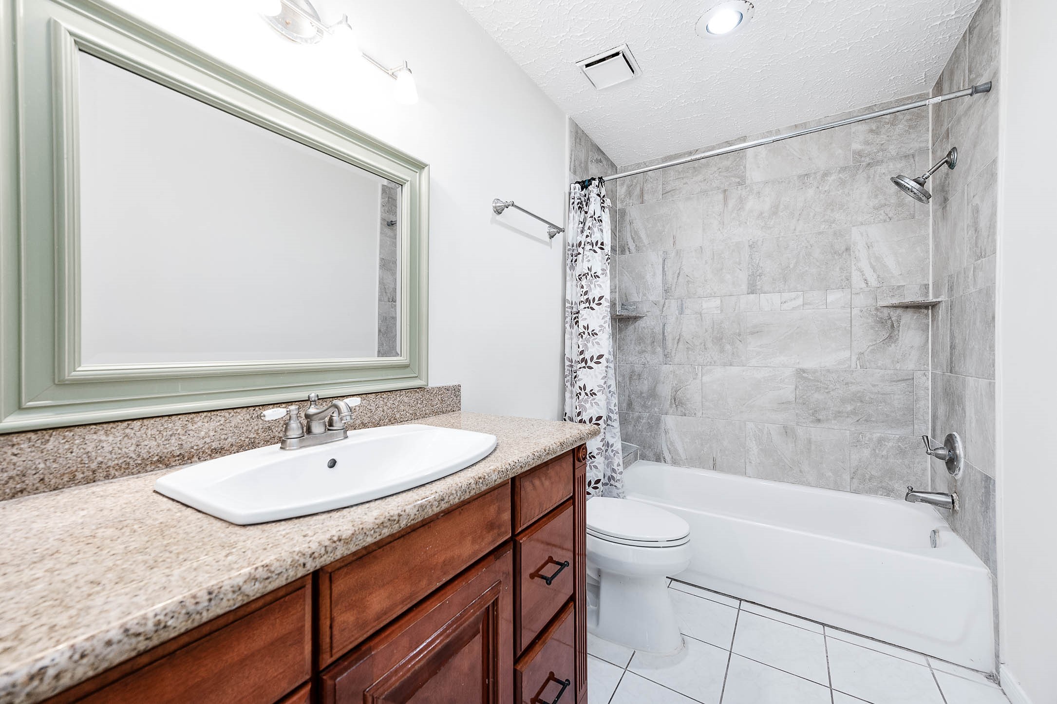 2015 Echo Ridge Sugar Land, TX 77478 - Photo 23 of 29 a bathroom with a granite countertop sink a toilet and shower