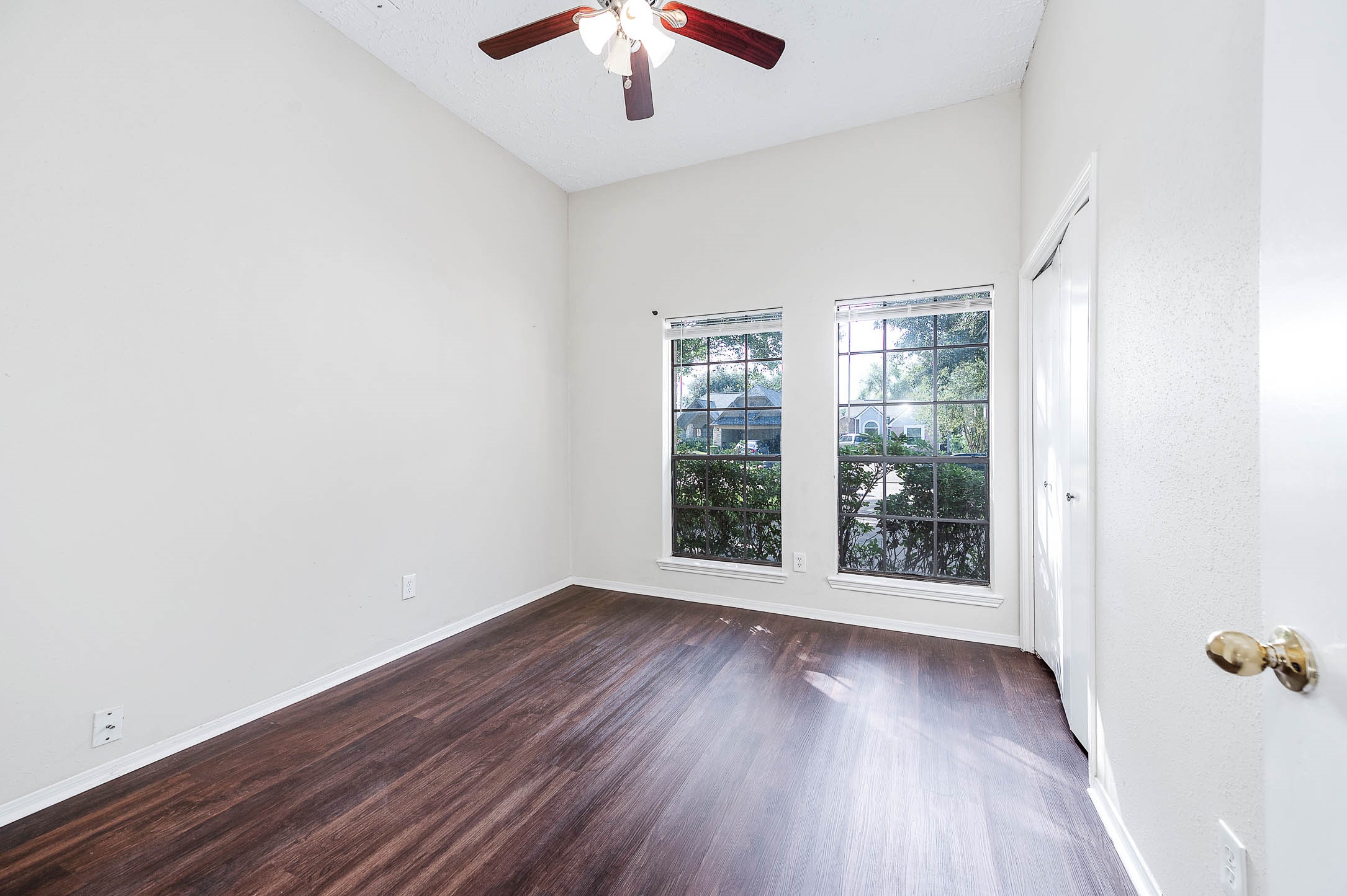2015 Echo Ridge Sugar Land, TX 77478 - Photo 24 of 29 an empty room with wooden floor and windows