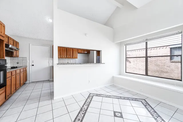 a view of a kitchen with a sink and dishwasher with wooden floor