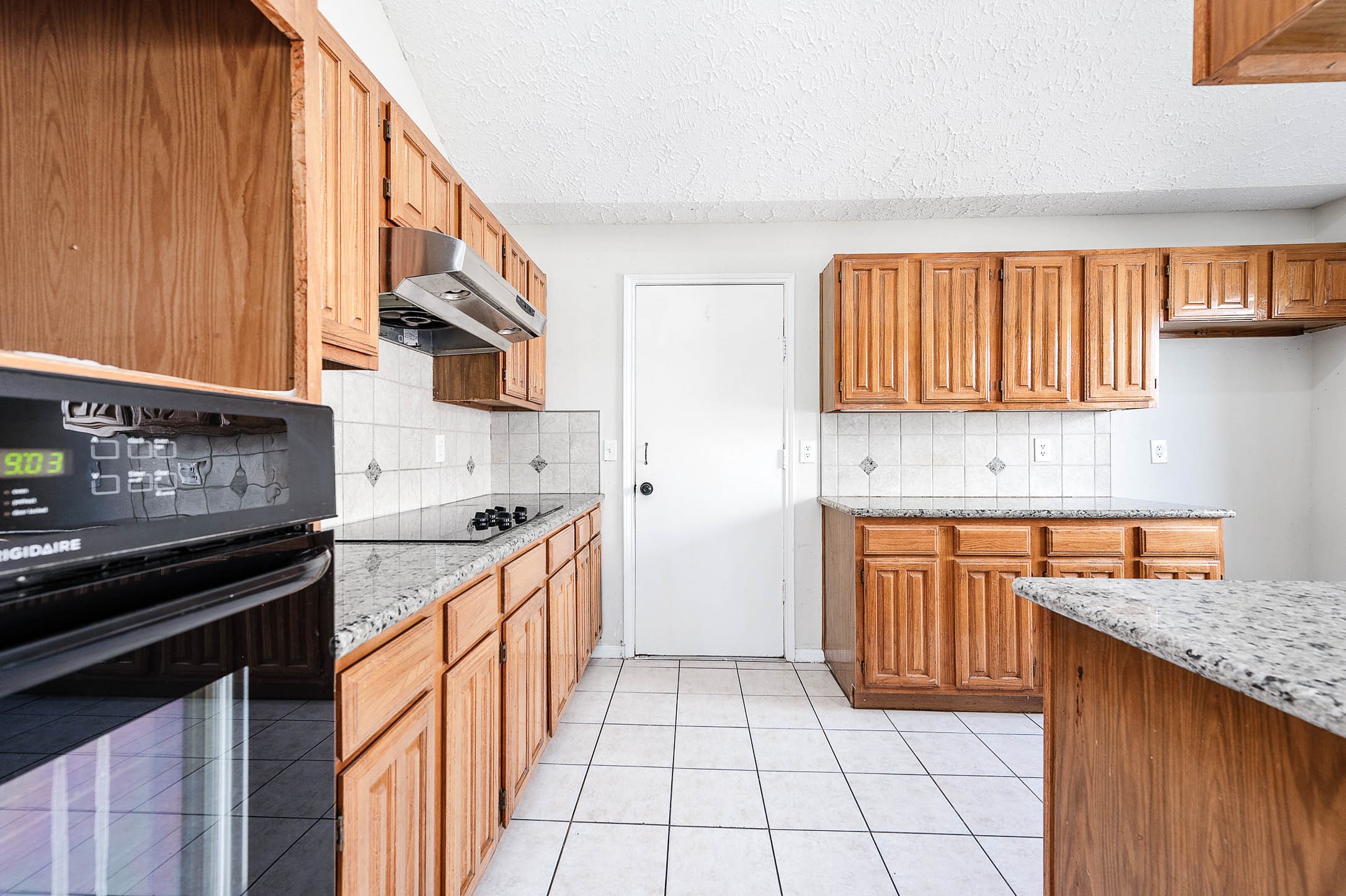2015 Echo Ridge Sugar Land, TX 77478 - Photo 10 of 29 a kitchen with stainless steel appliances granite countertop a stove a sink and a microwave