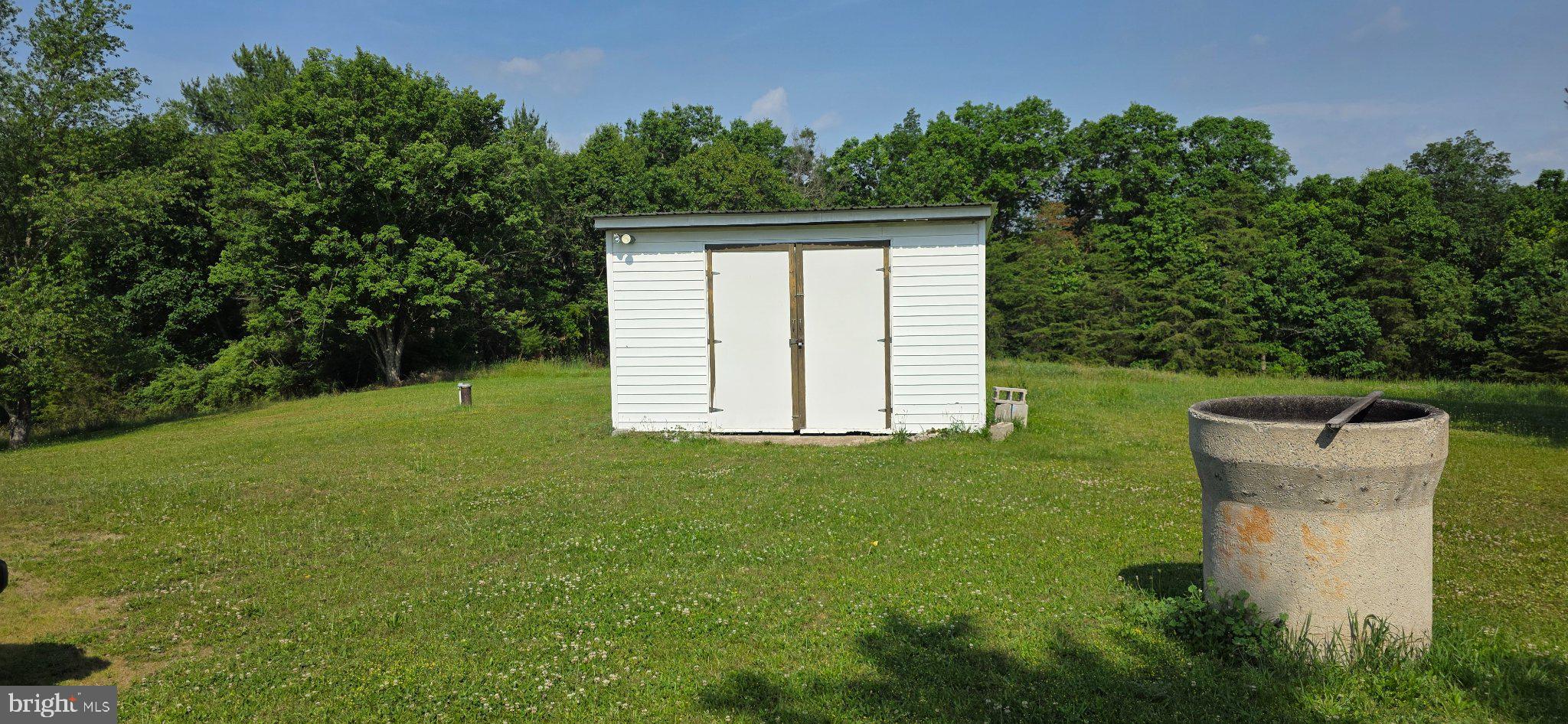 9000 Corner Road Hancock, MD 21750 - Photo 4 of 13 Serene landscape with a storage shed.