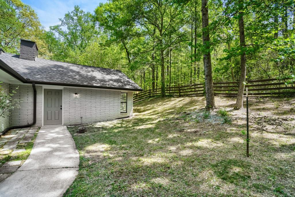 2021 Irwin Bridge Road Northwest Conyers, GA 30012 - Photo 4 of 43 a backyard of a house with lots of green space