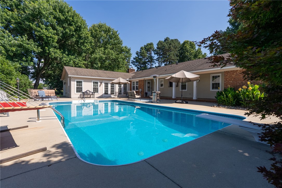 3513 Hopewell Road Anderson, SC 29621 - Photo 37 of 50 A tranquil backyard oasis features a glistening pool and mature landscaping, perfect for relaxation.