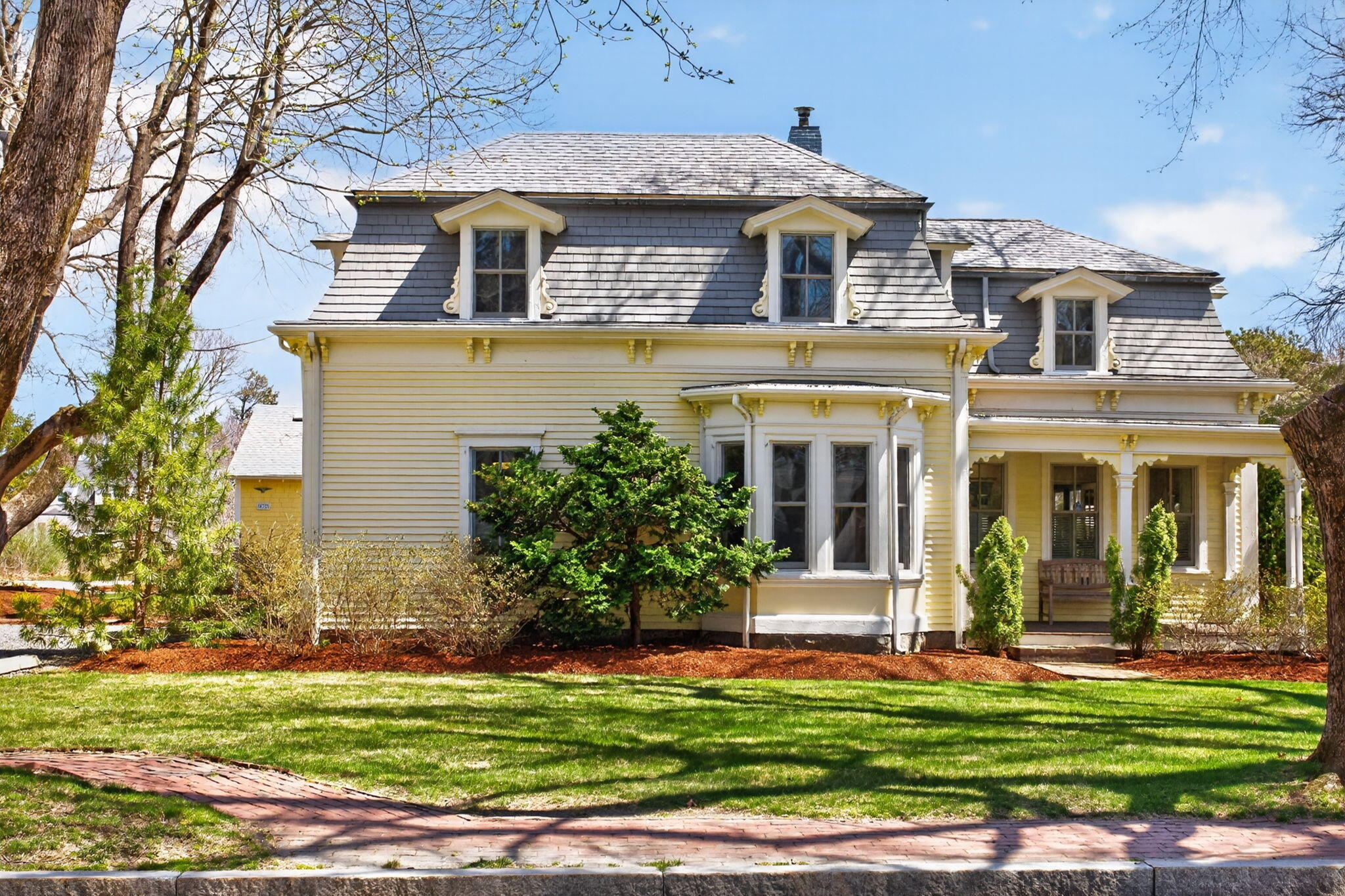 a front view of a house with a garden