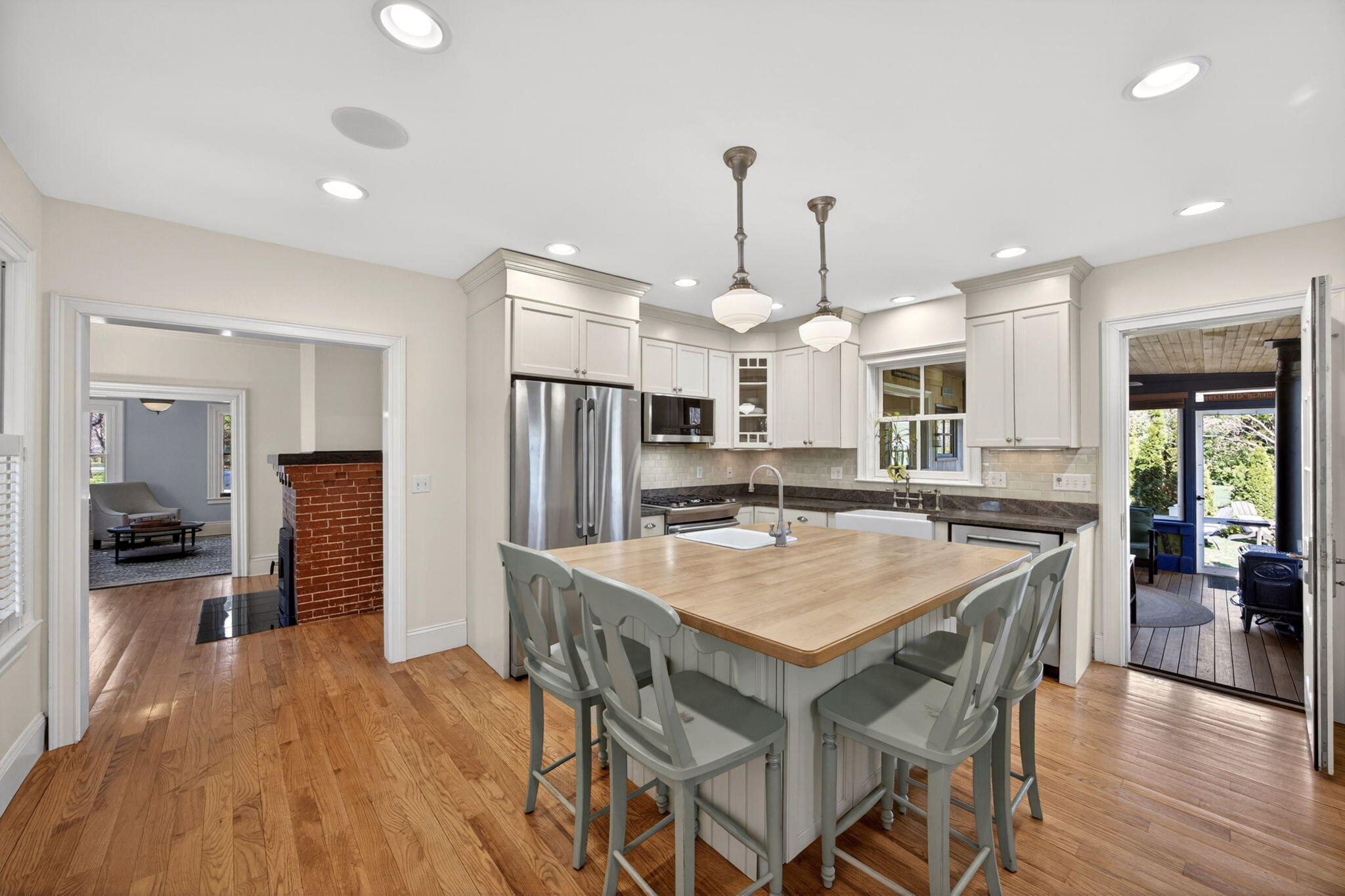 474 Davisville Road East Falmouth, MA 02536 - Photo 12 of 66 a kitchen with stainless steel appliances kitchen island granite countertop a table chairs and a refrigerator