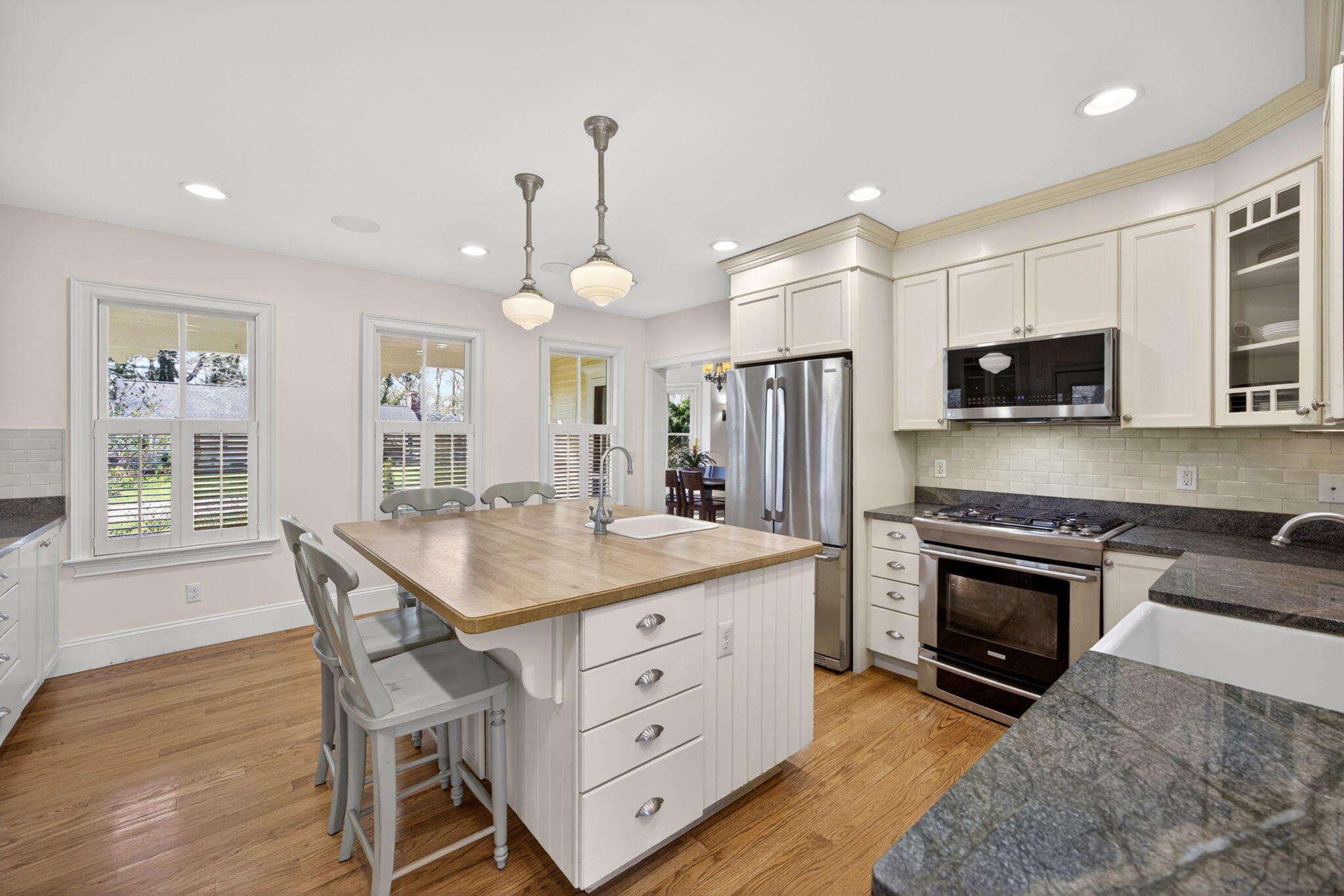 474 Davisville Road East Falmouth, MA 02536 - Photo 16 of 66 a kitchen with a stove a sink a microwave a refrigerator and wooden cabinets