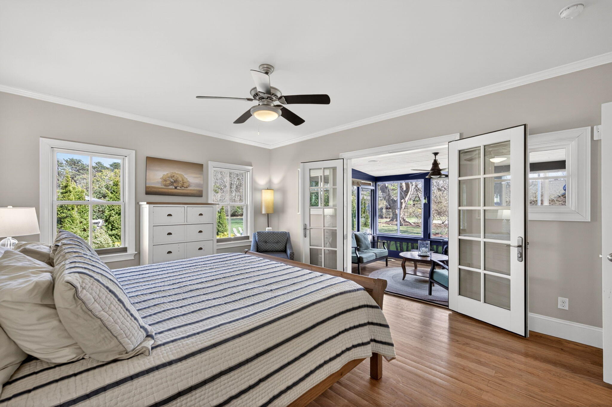 474 Davisville Road East Falmouth, MA 02536 - Photo 22 of 66 a bedroom with a large bed and a chandelier