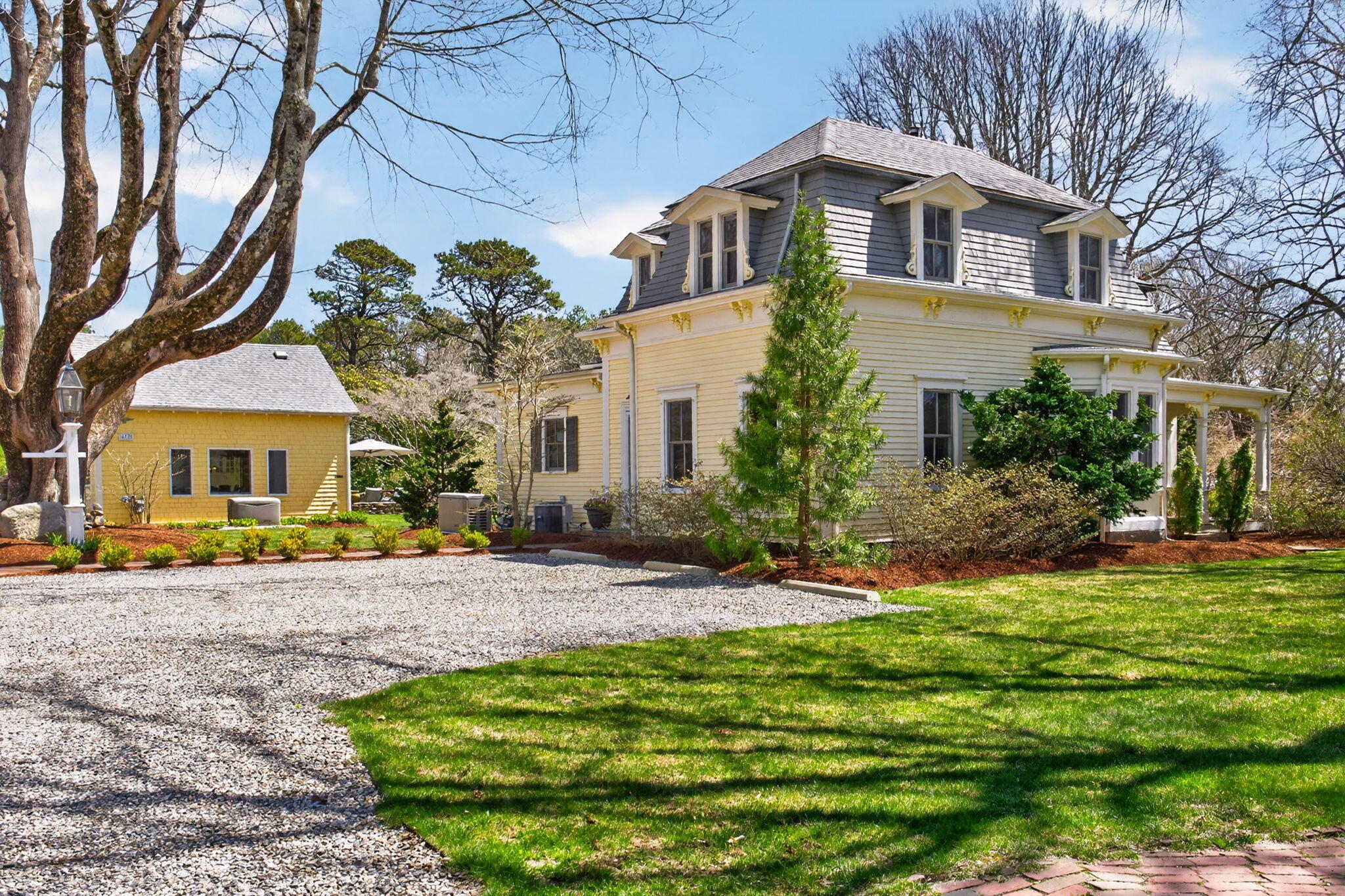 474 Davisville Road East Falmouth, MA 02536 - Photo 50 of 66 a front view of a house with a garden