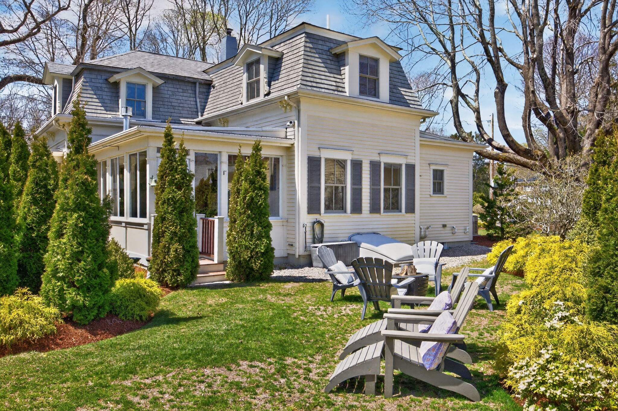 474 Davisville Road East Falmouth, MA 02536 - Photo 54 of 66 a view of a brick house with a chairs and table in a patio