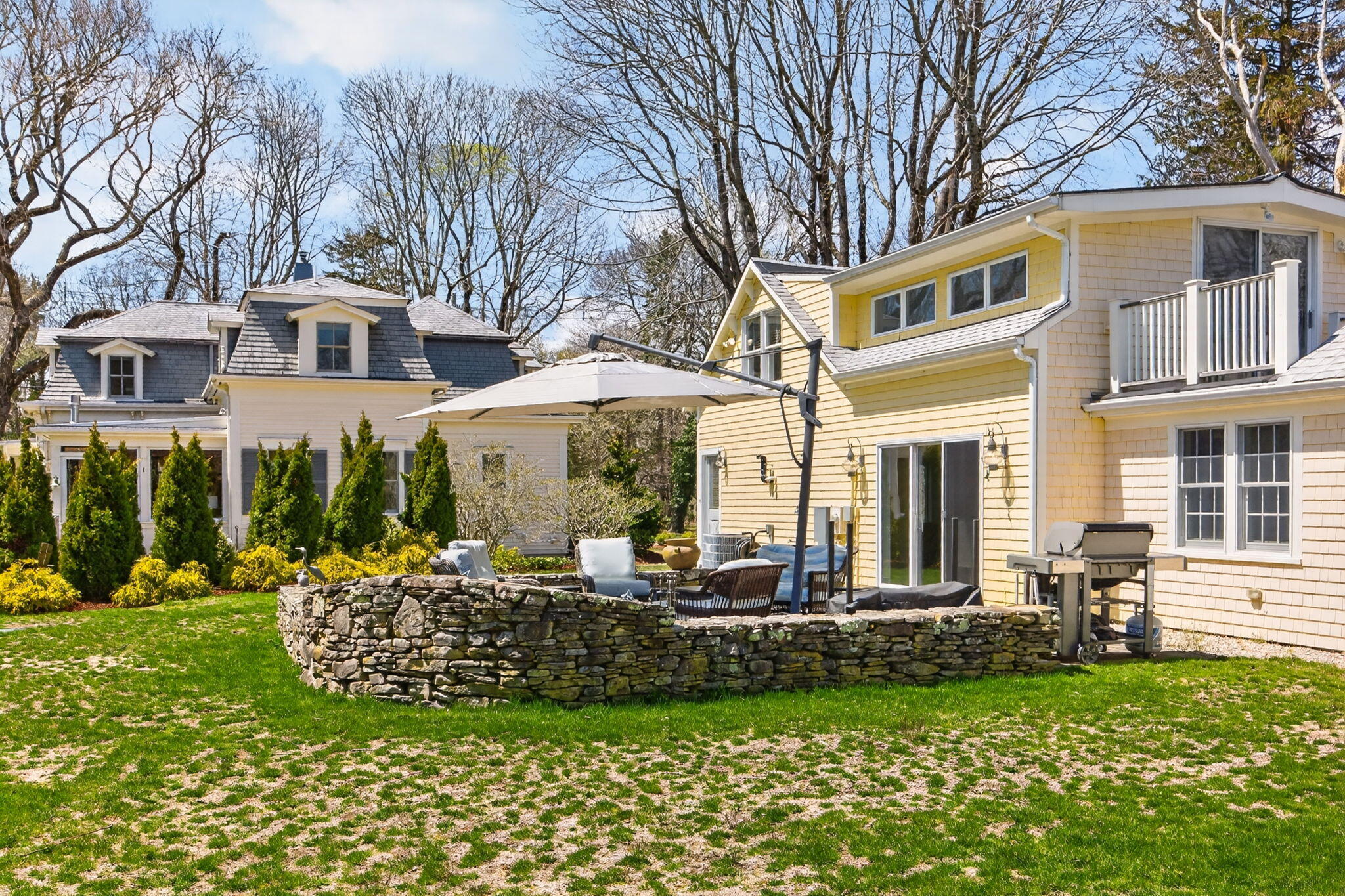 474 Davisville Road East Falmouth, MA 02536 - Photo 57 of 66 a front view of a house with a yard table and chairs