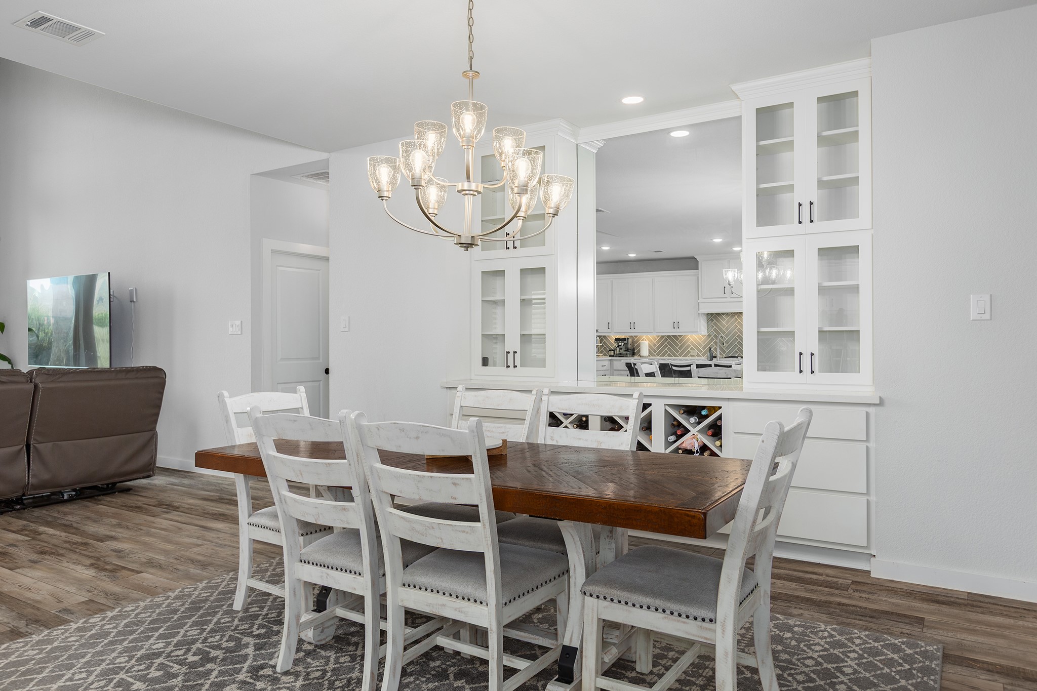 12110 Woodnote Lane Humble, TX 77346 - Photo 11 of 36 a view of a dining room with furniture a chandelier and wooden floor