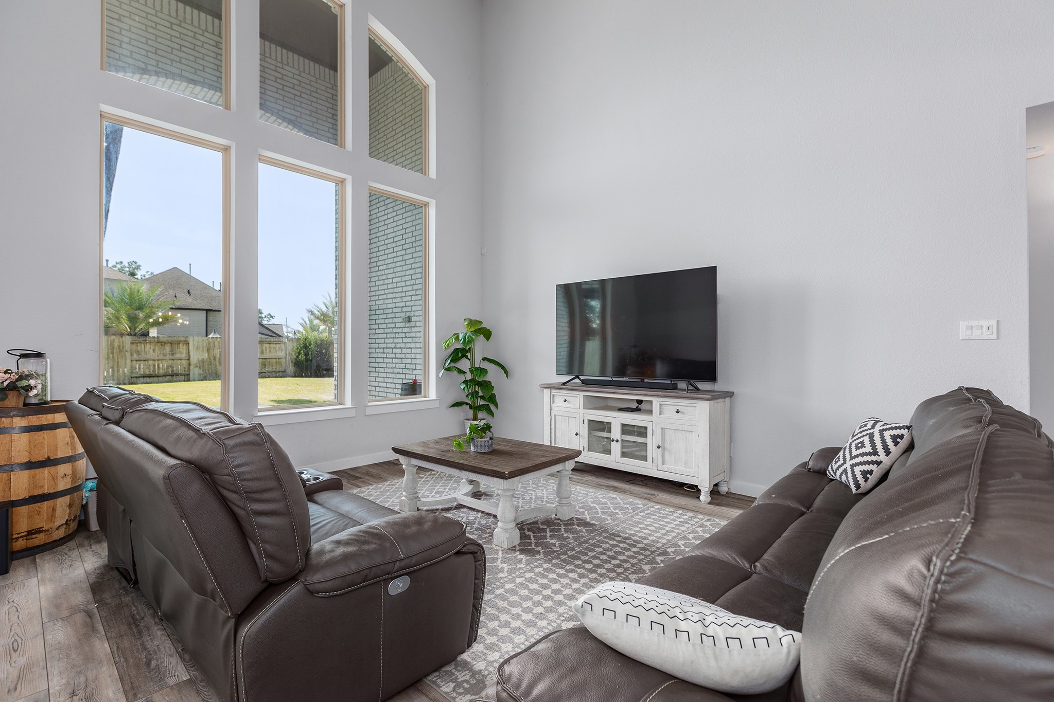 12110 Woodnote Lane Humble, TX 77346 - Photo 14 of 36 a living room with furniture a flat screen tv and a large window