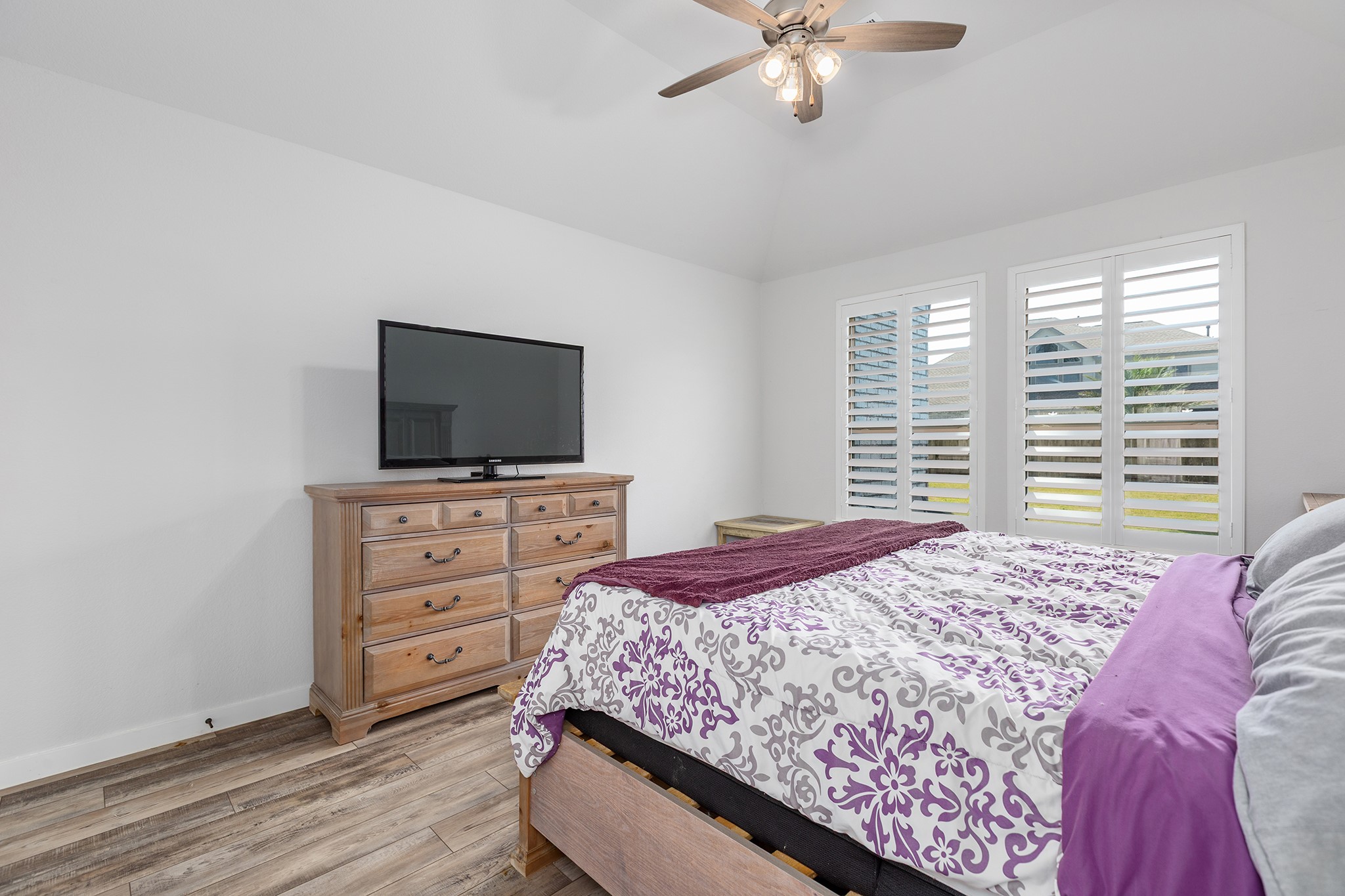 12110 Woodnote Lane Humble, TX 77346 - Photo 18 of 36 a bedroom with a bed and a flat screen tv